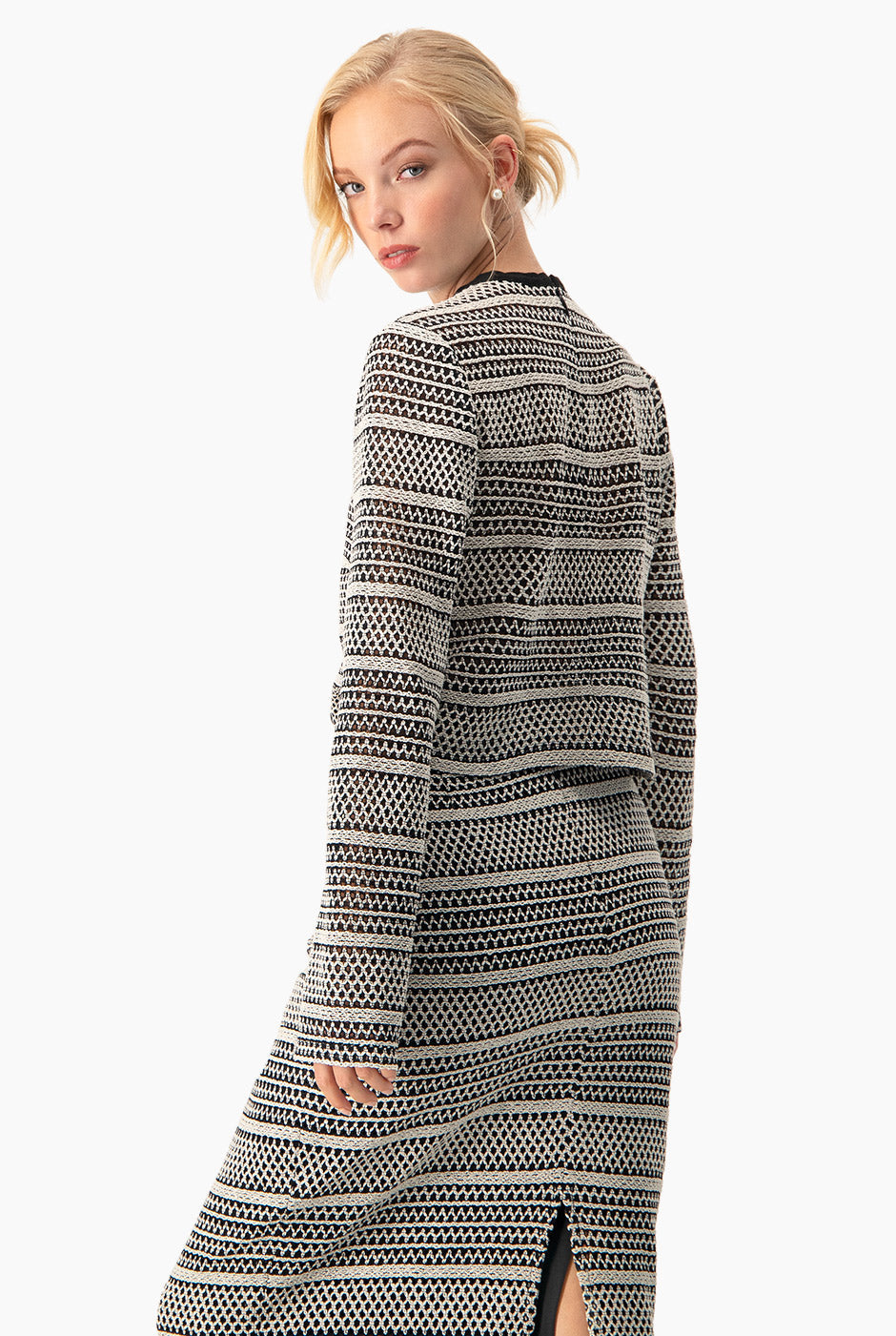 Top tejido corto negro con patrón geométrico y mangas largas