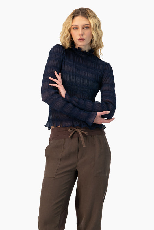 Blusa azul marino con cuello alto y olanes